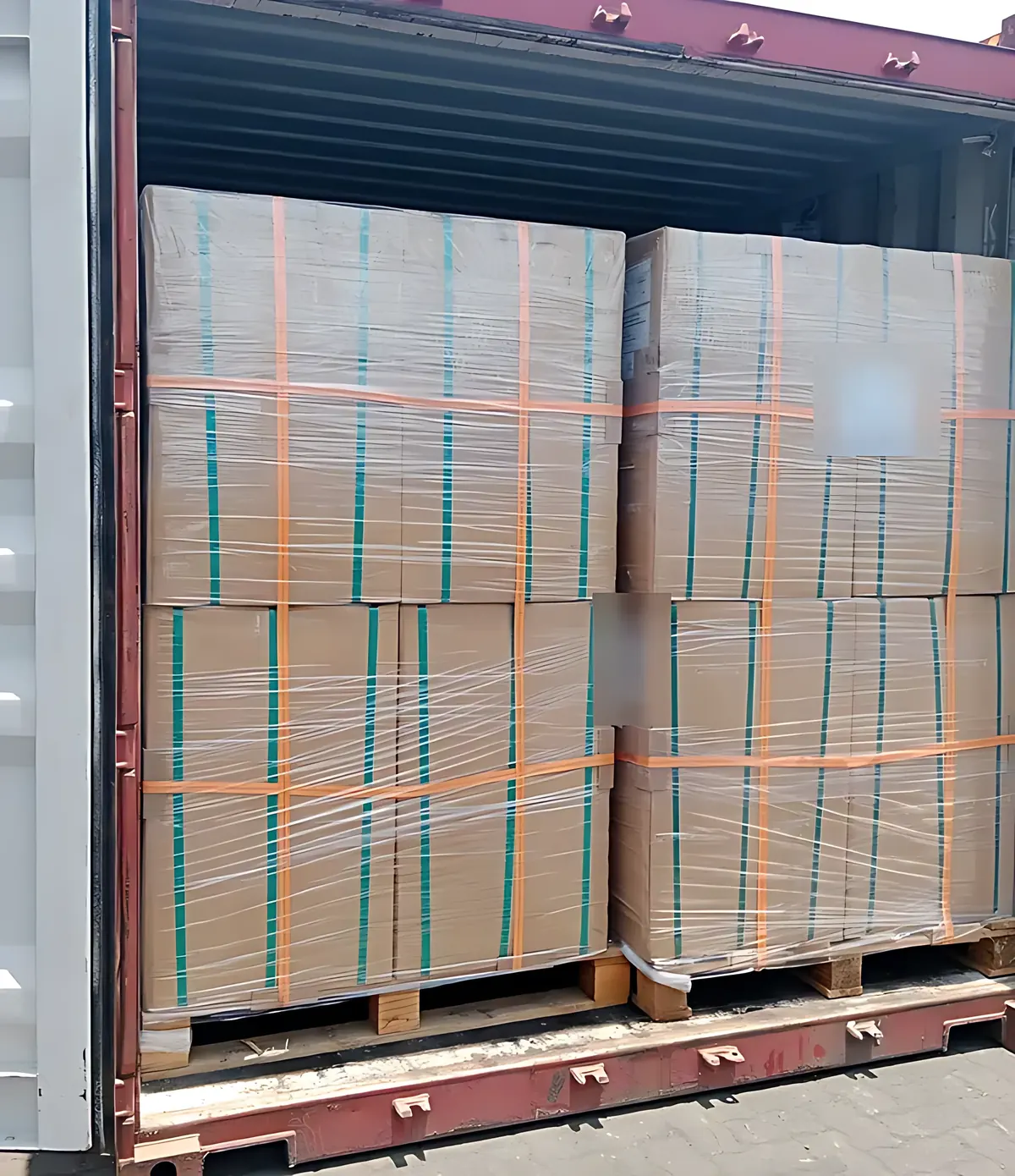 Wrapped and palletised cartons loaded inside a shipping container for export
